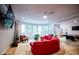 Bright living room with hanging pod chairs, plush red sofa, and large windows at 2015 Shaudi Ln, Atlanta, GA 30345