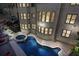 Aerial view of a luxurious swimming pool, jacuzzi, outdoor seating and backyard deck at 2015 Shaudi Ln, Atlanta, GA 30345