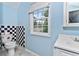 Cozy bathroom featuring black and white checkered tiles and a window providing natural light at 2949 Lake Spivey Pkwy, Jonesboro, GA 30236