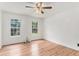 Bright bedroom with two windows, hardwood floors, ceiling fan, and ample natural light at 2949 Lake Spivey Pkwy, Jonesboro, GA 30236
