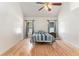 Bedroom with hardwood floors, two windows, vaulted ceilings, and a ceiling fan at 2949 Lake Spivey Pkwy, Jonesboro, GA 30236
