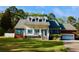Charming two-story home with a welcoming front porch, vibrant blue shutters, and well-manicured lawn at 2949 Lake Spivey Pkwy, Jonesboro, GA 30236