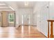 Bright and airy foyer with hardwood floors, a chandelier, and a view into the living space, showcasing a welcoming entrance at 2949 Lake Spivey Pkwy, Jonesboro, GA 30236