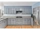 Functional kitchen with granite countertops, gray cabinetry, stainless steel appliances and hardwood floors providing ample cooking space at 2949 Lake Spivey Pkwy, Jonesboro, GA 30236