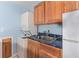 Laundry area features sink, washer and dryer, and wooden cabinetry at 2949 Lake Spivey Pkwy, Jonesboro, GA 30236