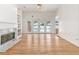Open living room featuring hardwood floors, built-in shelves, a marble fireplace, and french doors to the pool at 2949 Lake Spivey Pkwy, Jonesboro, GA 30236