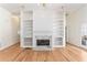 Bright open living room with hardwood floors, fireplace, built-in shelving, and access to the backyard at 2949 Lake Spivey Pkwy, Jonesboro, GA 30236
