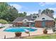Spacious backyard features a large swimming pool, patio, seating areas, and lush landscaping at 2949 Lake Spivey Pkwy, Jonesboro, GA 30236