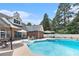 Large backyard with swimming pool, patio area, lounge seating and mature trees at 2949 Lake Spivey Pkwy, Jonesboro, GA 30236