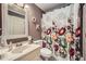 Charming bathroom featuring stylish floral shower curtain and marble countertops at 3635 Norwich Dr, Tucker, GA 30084