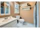 Well-lit bathroom featuring marble countertop, shelving, and modern fixtures at 3635 Norwich Dr, Tucker, GA 30084