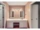 Bathroom vanity features decorative mirrors, lighting, and lots of storage space at 3635 Norwich Dr, Tucker, GA 30084