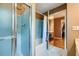 Bathroom with glass shower and tub combo next to large vanity area at 3635 Norwich Dr, Tucker, GA 30084