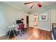 Comfortable bedroom featuring hardwood floors, a sleek desk, and access to an ensuite bathroom at 3635 Norwich Dr, Tucker, GA 30084