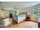 Large bedroom with hardwood floors, natural light, and ceiling fan at 3635 Norwich Dr, Tucker, GA 30084