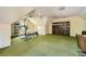 Bonus room with exercise equipment, bookcase, ceiling fans and bright green carpet at 3635 Norwich Dr, Tucker, GA 30084