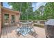 Inviting outdoor deck with table, chairs, pillows, and grill, perfect for entertaining guests at 3635 Norwich Dr, Tucker, GA 30084