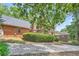Brick home featuring a backyard deck, lush greenery, and a winding driveway at 3635 Norwich Dr, Tucker, GA 30084