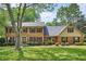 Beautiful two-story brick home with lush green lawn and mature landscaping, exudes classic elegance and charm at 3635 Norwich Dr, Tucker, GA 30084
