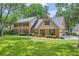 Charming brick home featuring a well-manicured lawn and mature trees, offering a serene and inviting curb appeal at 3635 Norwich Dr, Tucker, GA 30084