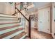 Elegant foyer with hardwood floors, a staircase with decorative spindles, and classic trim details at 3635 Norwich Dr, Tucker, GA 30084