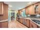 Well-appointed kitchen boasting granite countertops, wood cabinets, modern appliances, and hardwood flooring at 3635 Norwich Dr, Tucker, GA 30084