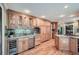 Bright kitchen featuring wood cabinets, granite countertops, stainless steel appliances, wine cooler, and hardwood floors at 3635 Norwich Dr, Tucker, GA 30084