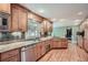 Well-lit kitchen featuring wood cabinets, granite countertops, stainless steel appliances, and hardwood floors at 3635 Norwich Dr, Tucker, GA 30084