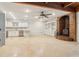 Spacious basement with a kitchen, a wood-burning fireplace, tile floors, and wood beam ceilings at 5250 Aubrey Ln, Cumming, GA 30028