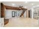 Open floor plan featuring a kitchen, a wood burning fireplace, tile floors, and a wooden staircase at 5250 Aubrey Ln, Cumming, GA 30028