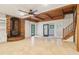 Open floor plan featuring a kitchen, a wood burning fireplace, tile floors, and wood beam ceilings at 5250 Aubrey Ln, Cumming, GA 30028