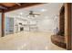 Spacious basement featuring a kitchen, a wood-burning fireplace, tile floors, and white cabinets at 5250 Aubrey Ln, Cumming, GA 30028
