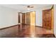 Bedroom features hardwood floors and multiple doors to other rooms at 5250 Aubrey Ln, Cumming, GA 30028