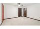 Spacious bedroom with carpet, a ceiling fan, and multiple doors at 5250 Aubrey Ln, Cumming, GA 30028
