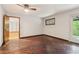 Bedroom with wood floors, a small window, and a door leading to the outside at 5250 Aubrey Ln, Cumming, GA 30028