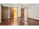 Bedroom features hardwood floors and multiple doors to other rooms at 5250 Aubrey Ln, Cumming, GA 30028