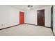Bedroom with carpet, ceiling fan, and bright-colored door at 5250 Aubrey Ln, Cumming, GA 30028