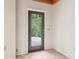 Hallway featuring tile flooring and a dark-framed glass door looking out to a wooded yard at 5250 Aubrey Ln, Cumming, GA 30028