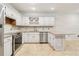 Kitchen featuring white cabinets, a tile backsplash, stainless steel appliances, and granite countertops at 5250 Aubrey Ln, Cumming, GA 30028
