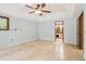 Spacious main bedroom featuring tile floors, a ceiling fan and bathroom at 5250 Aubrey Ln, Cumming, GA 30028