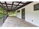 Covered outdoor patio with stone flooring and black iron railing at 5250 Aubrey Ln, Cumming, GA 30028