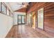 Sunroom with tile floors, wood-paneled walls, and large windows at 5250 Aubrey Ln, Cumming, GA 30028