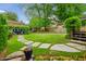 Spacious backyard featuring a stone pathway and a large grassy area, perfect for outdoor activities at 933 N Highland Ne Ave, Atlanta, GA 30306
