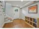 Basement entryway with hardwood floors, stairs, and a white front door at 933 N Highland Ne Ave, Atlanta, GA 30306