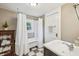 Bathroom with white tile, a shower and tub combination, and a white pedestal sink at 933 N Highland Ne Ave, Atlanta, GA 30306