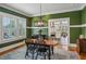 Green dining area with natural light, a wooden table, and a view into the kitchen at 933 N Highland Ne Ave, Atlanta, GA 30306