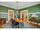 Inviting dining room features a wooden table, stylish lighting, and warm green walls at 933 N Highland Ne Ave, Atlanta, GA 30306