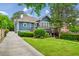 Charming home with a lush green lawn, featuring a deck, lower patio, and well-maintained landscaping at 933 N Highland Ne Ave, Atlanta, GA 30306