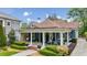 Charming blue home featuring a welcoming front porch with white columns and beautifully landscaped front yard at 933 N Highland Ne Ave, Atlanta, GA 30306