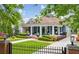 Inviting blue home with a classic front porch, well-manicured lawn, and charming curb appeal at 933 N Highland Ne Ave, Atlanta, GA 30306